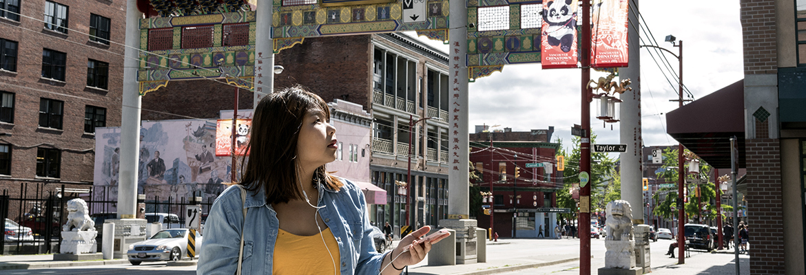UBC alumna Ernielly Leo uses an augmented reality app to tour Vancouver's historic Chinatown neighbourhood. Developed by UBC professor Siobhn McPhee and students, the app is a historical walking tour that uses geolocation and audio files to enhance a user's experience. (Photo by Abigail Saxton)